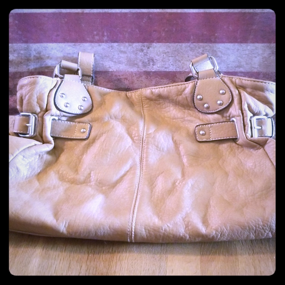 Tan leather purse with silver detailing.
